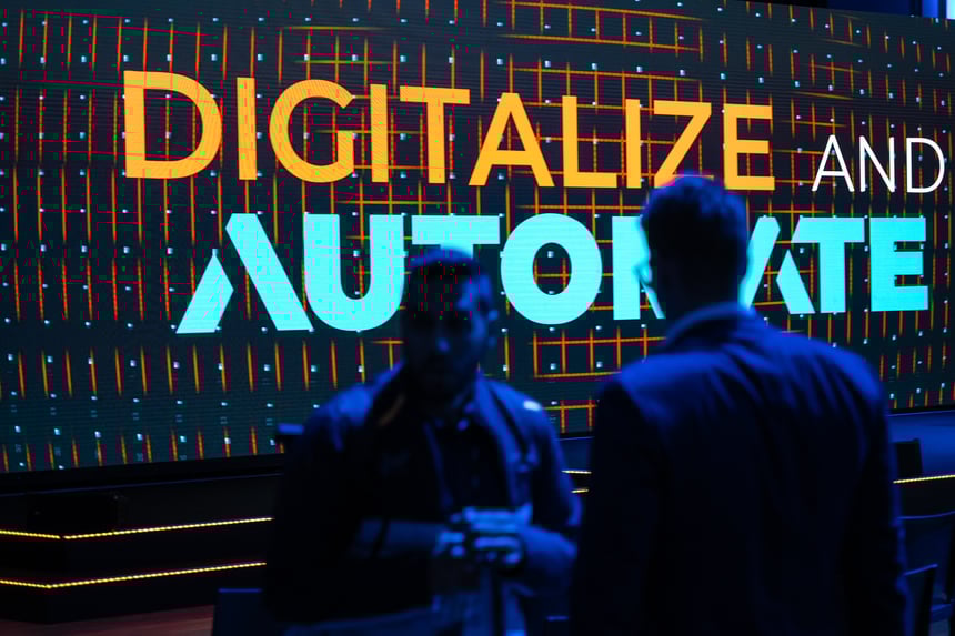 Two men standing in front of the Digitalize And Automate logo at the event in Frankfurt